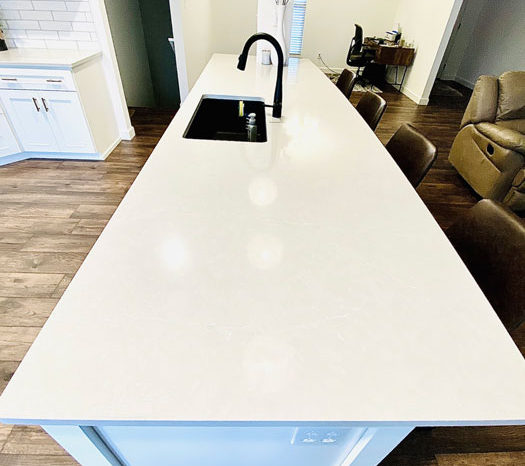 white-countertop-kitchen-island-black-fixtures-the-design-studio-breese-image